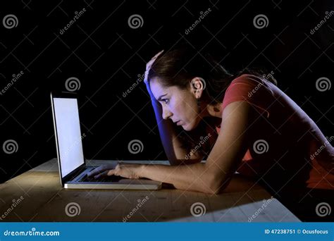 Young Concentrated Freelance Worker or Student Woman Working with Computer Laptop Alone Late at ...