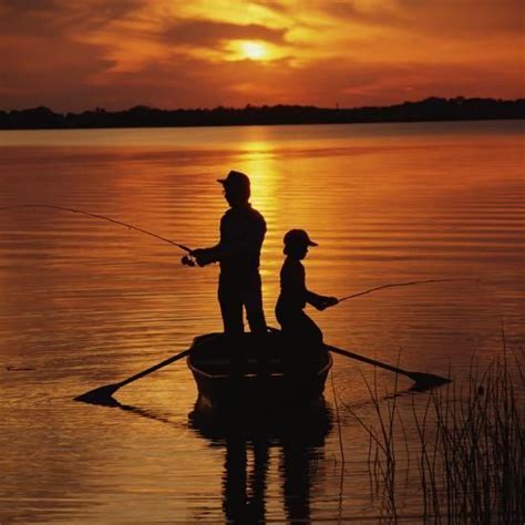 Silhouette of Father and Son Fishing at Sunset-Dennis Hallinan ...