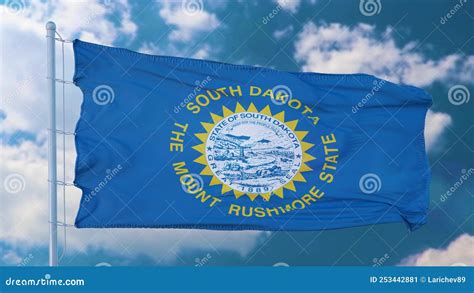 South Dakota Flag on a Flagpole Waving in the Wind, Blue Sky Background ...