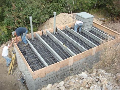 two men working on the foundation of a house