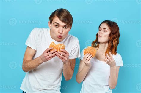 man and woman in t-shirts with hamburgers in the hands of fast food diet 22058746 Stock Photo at ...