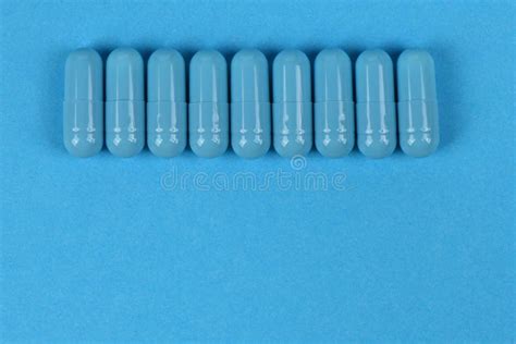 Blue Medical Capsules Pill on Blue Background. High Resolution Photo ...