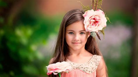 Cute Little Girl Is Having Big Pink Flower On Head Standing In Green ...