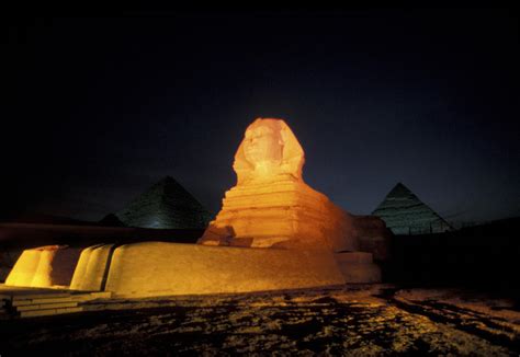 Pyramids And A Sphinx At Night In Giza by Richard Nowitz