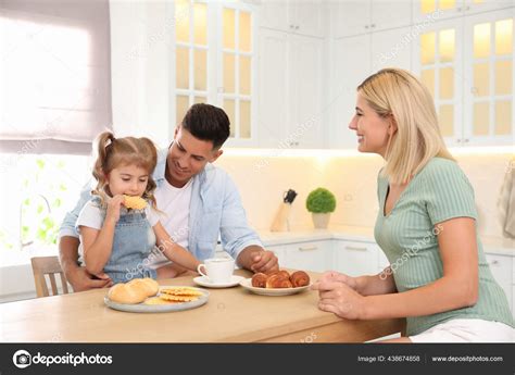 Happy Family Eating Together Table Modern Kitchen Stock Photo by ©NewAfrica 438674858