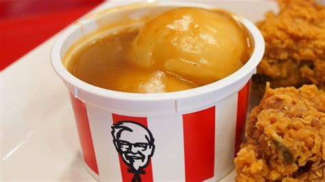 an image of fried food in a cup on a plate with sauce and ice cream