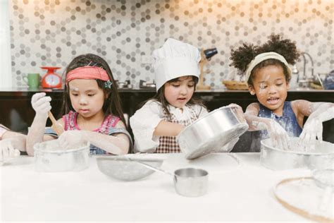 Group of kids are preparing the bakery in the kitchen .Children learning to cooking cookies ...