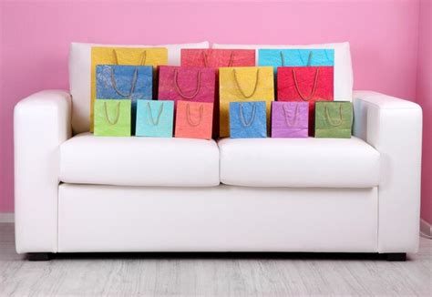 Premium Photo | Colorful shopping bags on sofa on color wall background