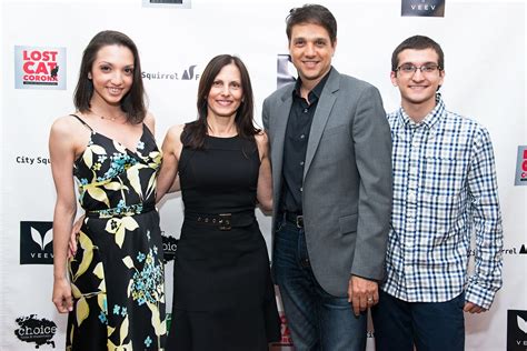 three people standing next to each other on a red carpet