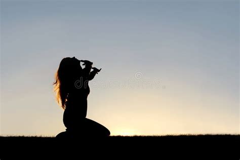 Silhouette of Woman Kneeling in Prayer and Surrender Stock Image - Image of silhouette ...