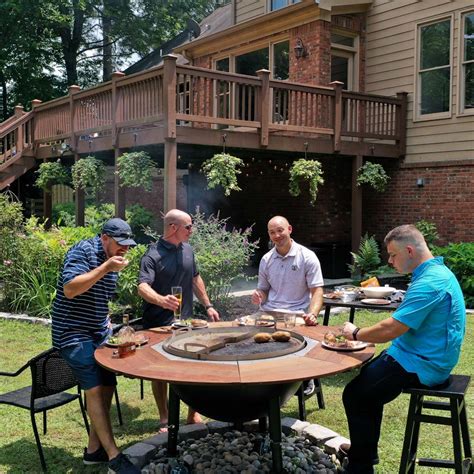 A griddle, smoker, firepit grill table combo