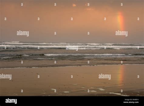 A rainbow appears at sunrise above the Pacific Ocean near Tillicum ...