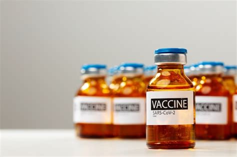 Premium Photo | Sars-cov-2 vaccine vial bottles on white table close up