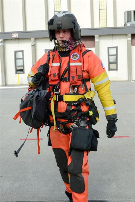 Petty Officer 1st Class Justin Munk, an aviation survival technician, walks in full cold weather ...