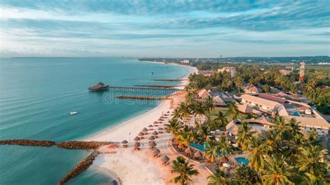 Aerial View of a Sunny Beach and Palm Trees by Piers in a Resort in Dar ...