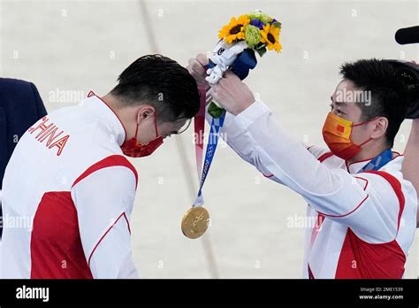 You Hao, of China, right, puts the gold medal on teammate Liu Yang, of ...