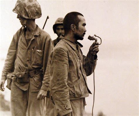 Japanese soldier, taken prisoner during the Battle of Saipan, uses a ...