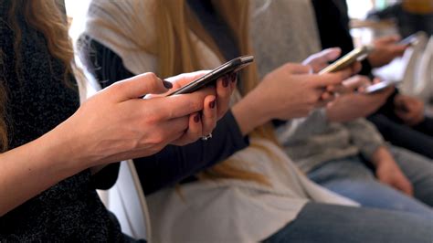 Group of people using mobile phones in a cafe instead of communicating ...