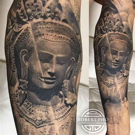 a man's leg with a tattoo on it and an image of a buddha