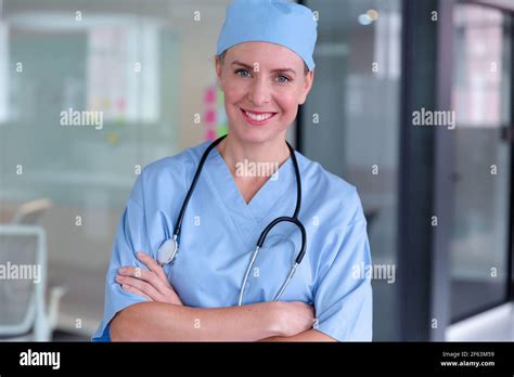 Portrait of smiling caucasian female doctor wearing scrubs and stethoscope Stock Photo - Alamy