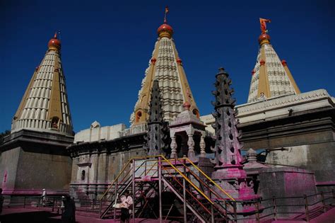 two tall buildings with red and yellow spires