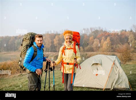 Couple hiking with backpacks Stock Photo - Alamy