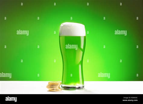 Glass of fresh cold green beer on a wooden bar counter in pub Stock Photo - Alamy