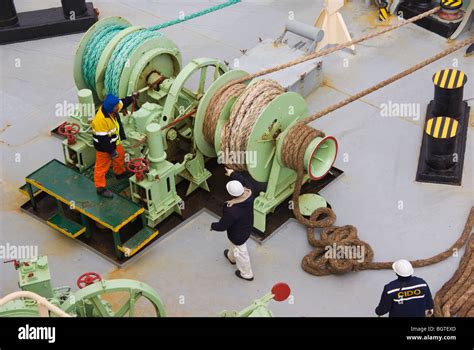 Crew on the bow of a ship involved in mooring operations after Stock Photo: 27583429 - Alamy