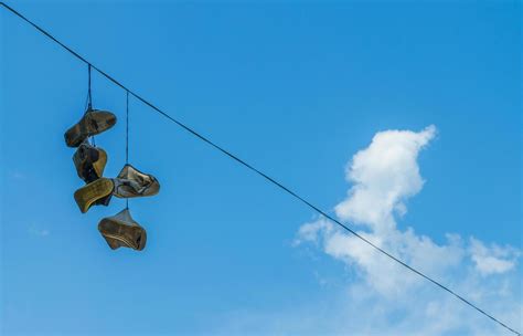 Shoes on the power line 2167226 Stock Photo at Vecteezy