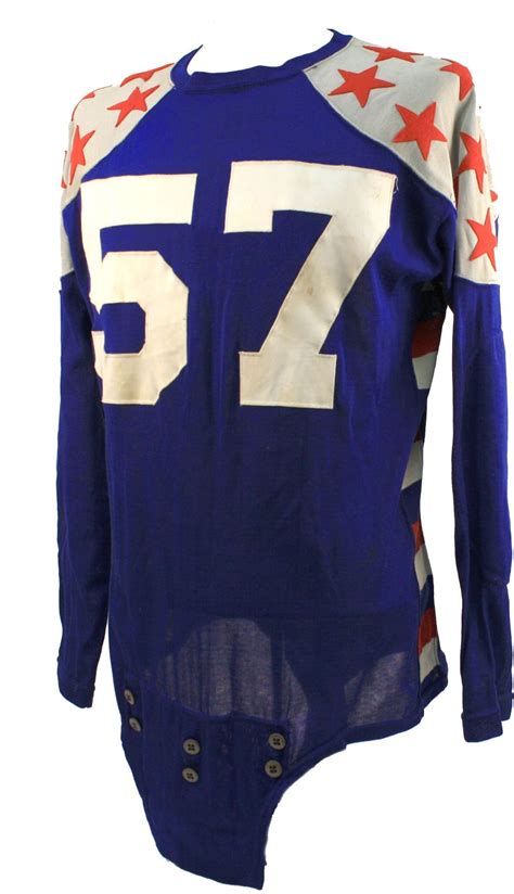 a blue and white football jersey with red stars on the sleeves, number seventy seven