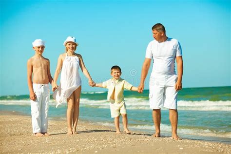 Family Walking Along the Beach Stock Photo - Image of people, female: 19793218