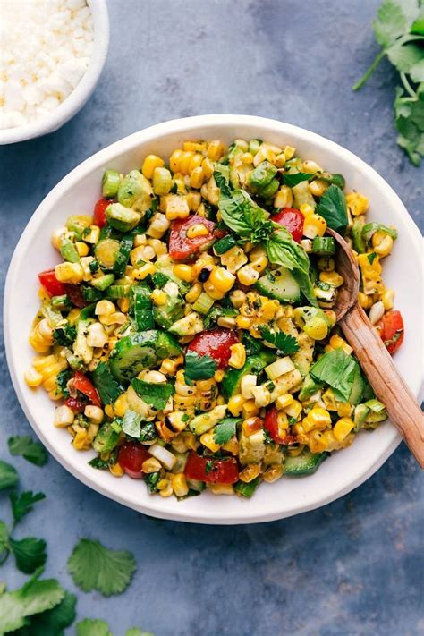 A simple and tasty corn salad with lots of veggies, herbs, and feta cheese. This salad is tossed ...