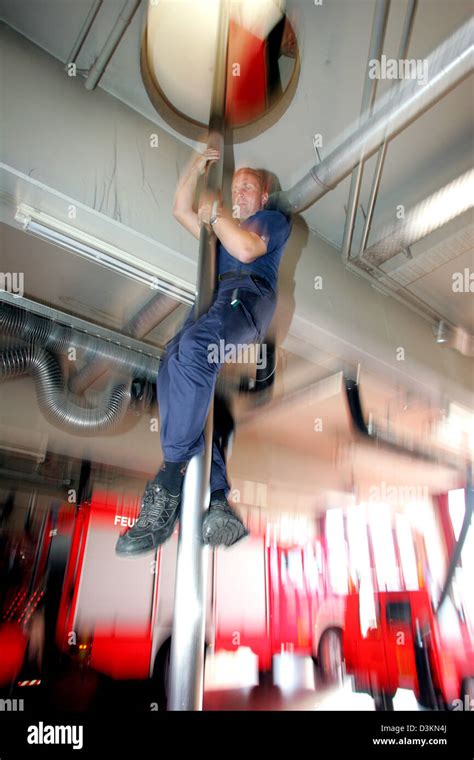 Firefighter slides down pole fire hi-res stock photography and images ...