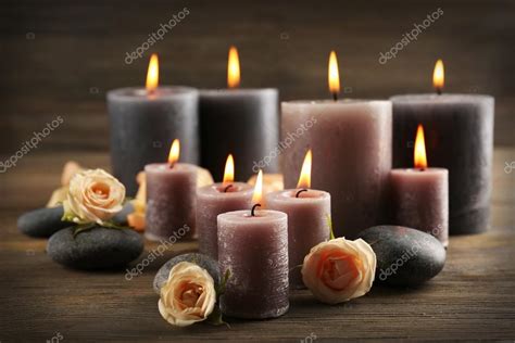 Alight wax grey candles with roses on wooden background — Stock Photo ...