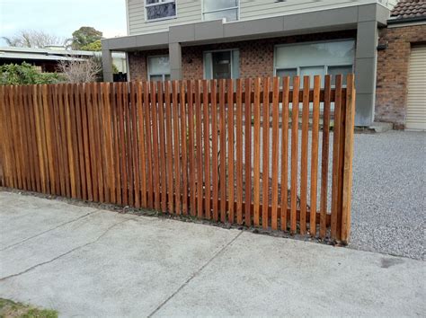 a wooden fence in front of a house