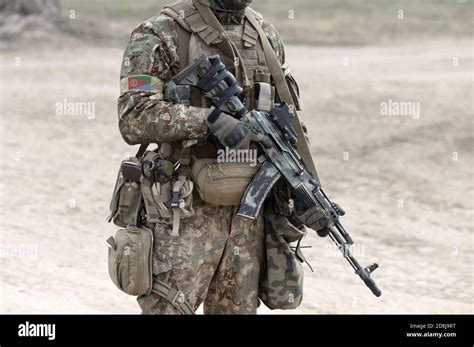 Soldier with assault rifle and flag of Eritrea on military uniform ...