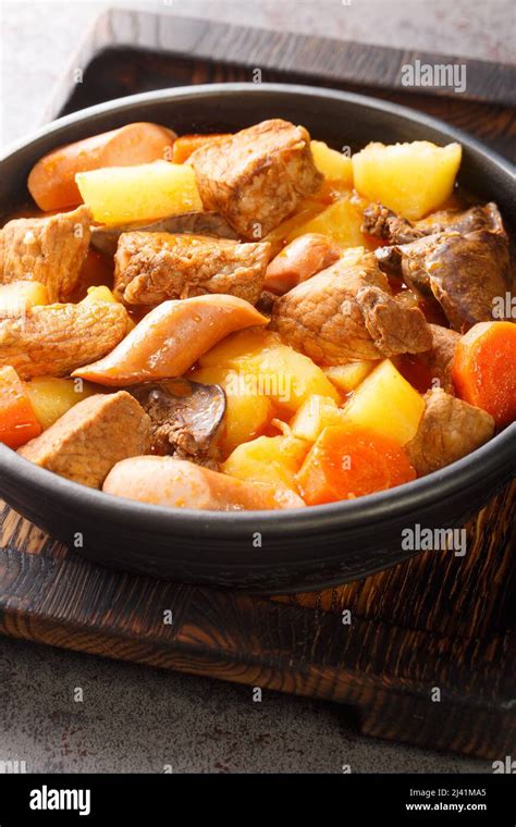 Filipino Menudo is a hearty and tasty pork stew made with fresh tomatoes, potatoes, carrots ...