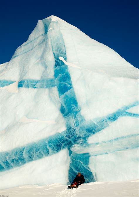 Icebergs as you've never seen them before: Incredible pictures of giant glaciers with black ...