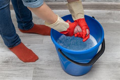 Woman Wringing Out a Wet Rag in a Bucket Stock Photo - Image of dirt ...