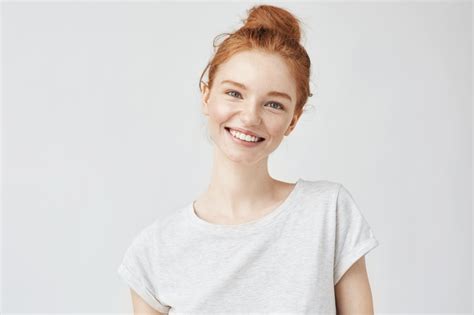 Headshot Portrait of happy ginger girl with freckles smiling looking at ...