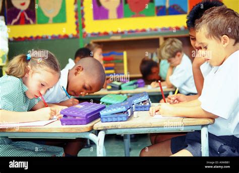 Multicultural children writing in classroom Johannesburg Gauteng Stock Photo: 2317232 - Alamy