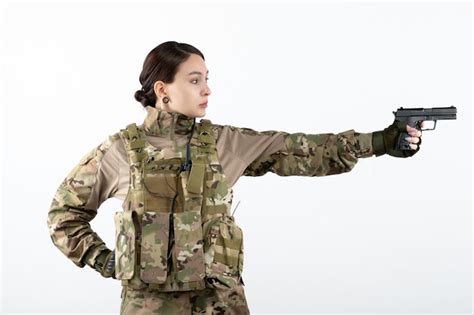 Premium Photo | Front view of female soldier in military uniform with gun white wall