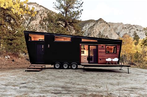 This tiny home features a bedroom loft and fold-out deck to balance ...