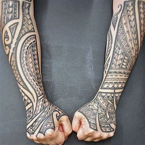 two people with tattoos on their arms holding hands in the shape of an ...