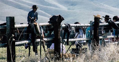 Cowboys Leaning on Brown Fence · Free Stock Photo