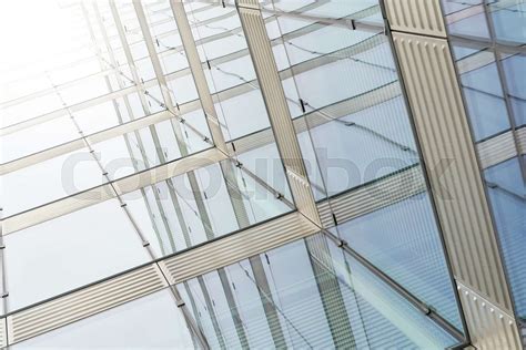 Glass facade of an office building with strong sunlight in the center ...