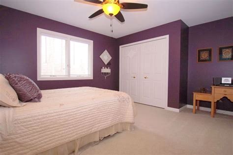 A beautiful shade of eggplant purple paint makes for a cozy bedroom. #realestate #Michigan ...