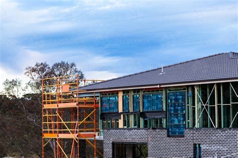 Image of Scaffolding up around double storey new house build on construction site - Austockphoto