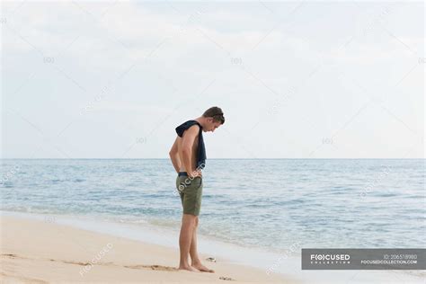 Man standing on the beach — caucasian, freedom - Stock Photo | #206518980