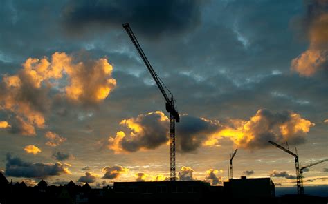 Jib crane at a construction site on a background of clouds wallpapers and images - wallpapers ...